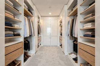 Dressing 2 personnes bien organisé avec étagères ouvertes et allée centrale compacte dans un appartement moderne
